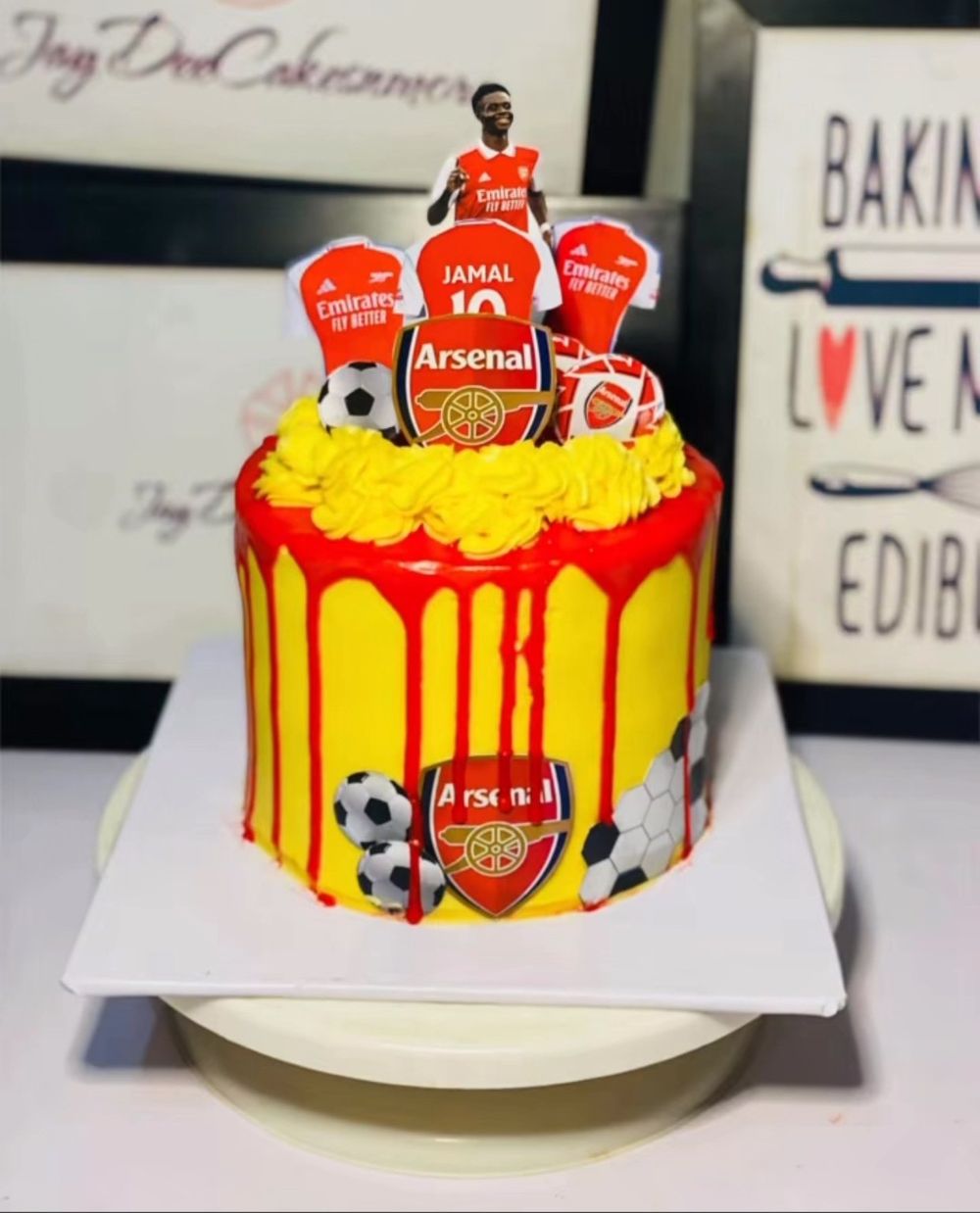 Arsenal football themed birthday cake with red drip, jerseys and club badge